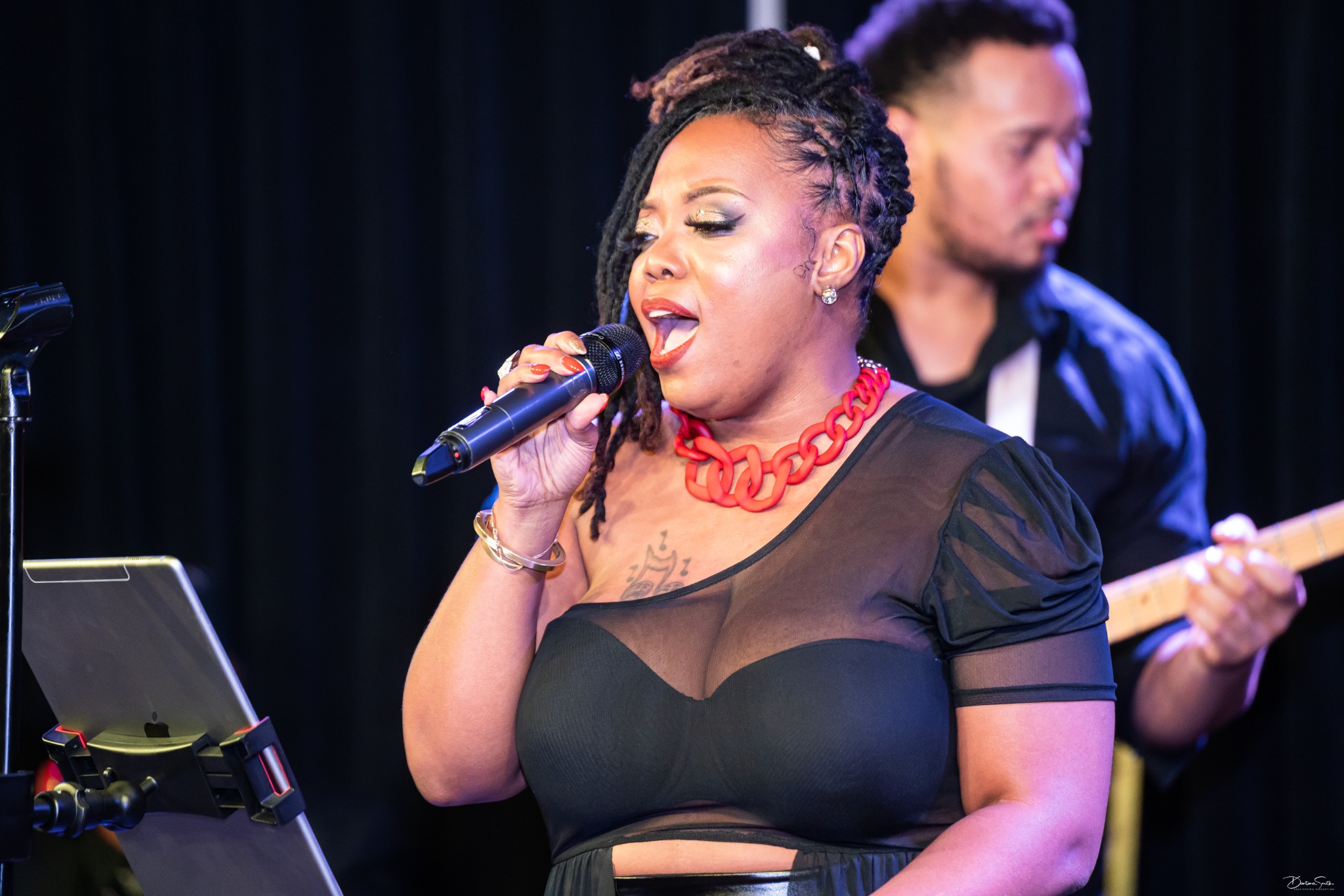 Close portrait of Erica Denise singing live