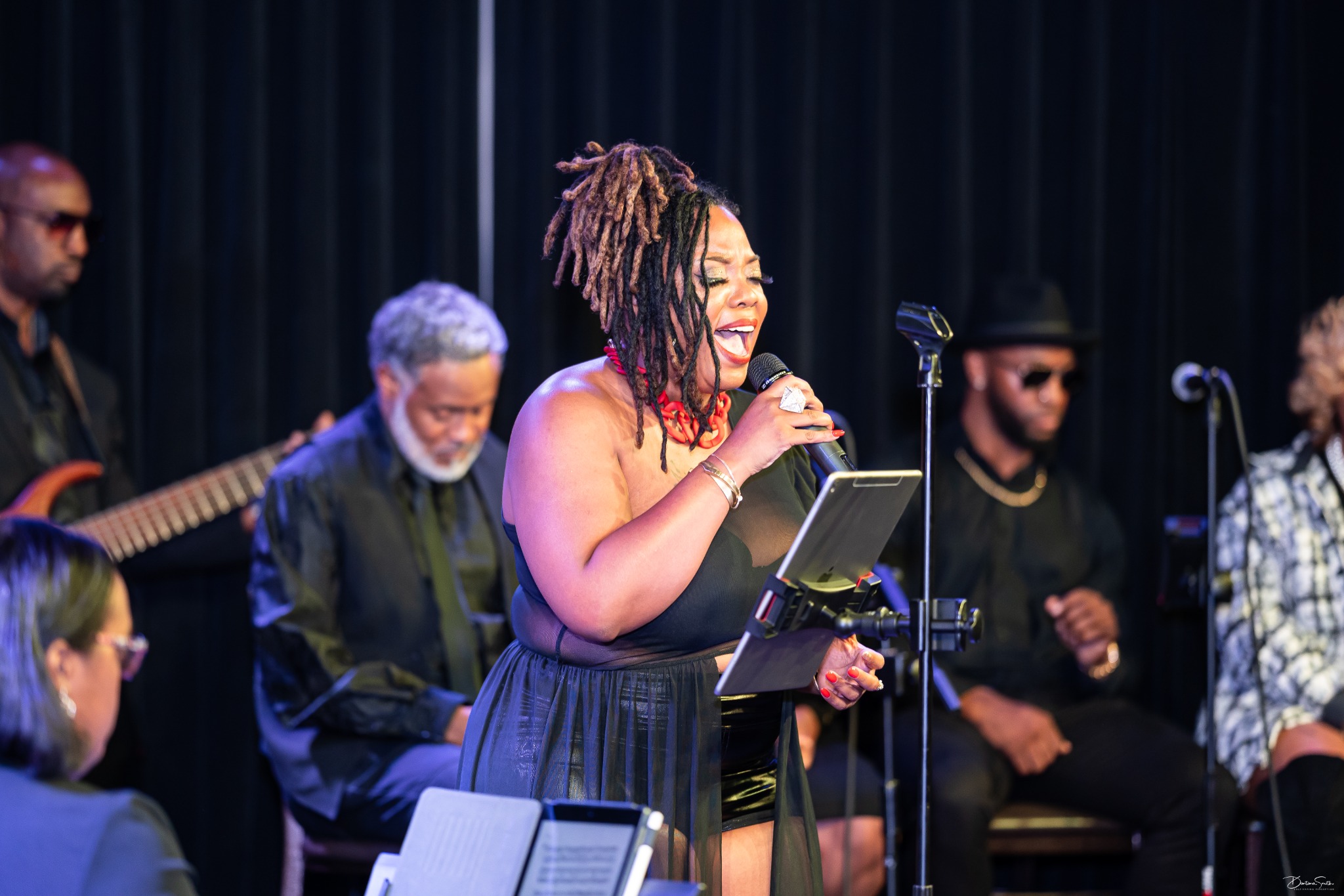 Erica Denise singing live with a band