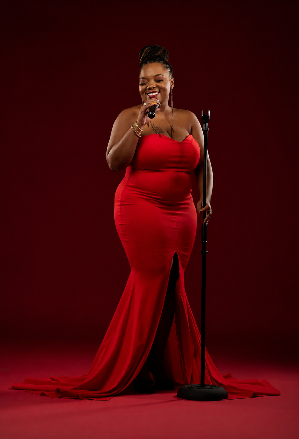 Erica Denise singing in a red gown